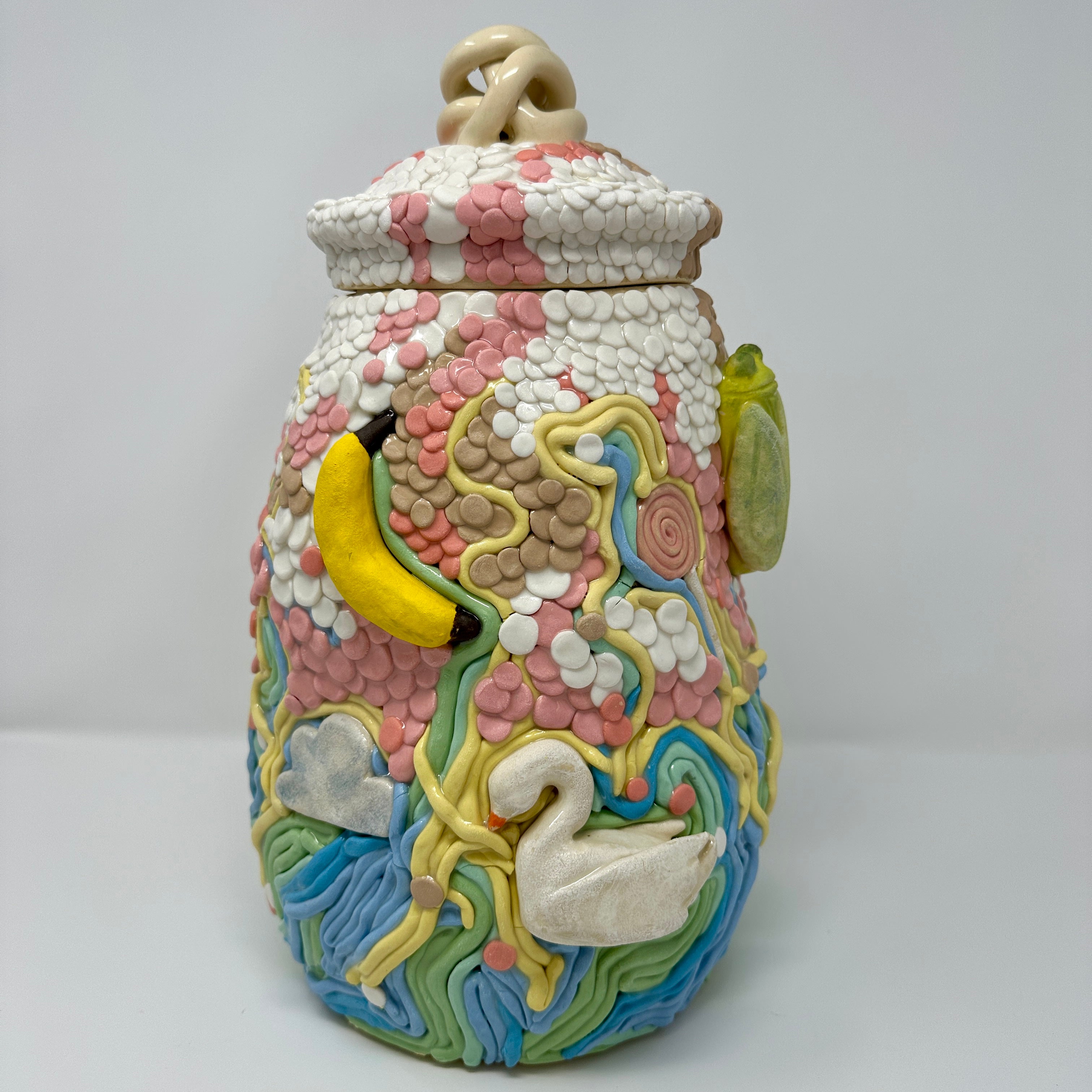 Decorative ceramic jar with colorful designs on a white background