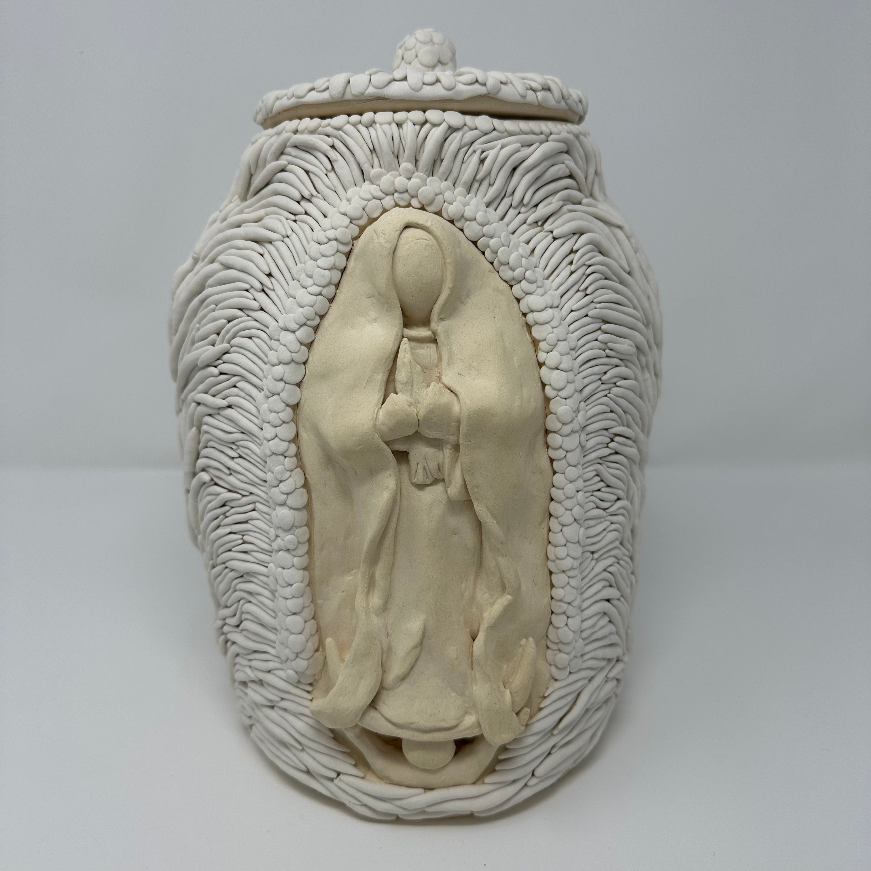 Decorative ceramic jar with intricate designs on a white background