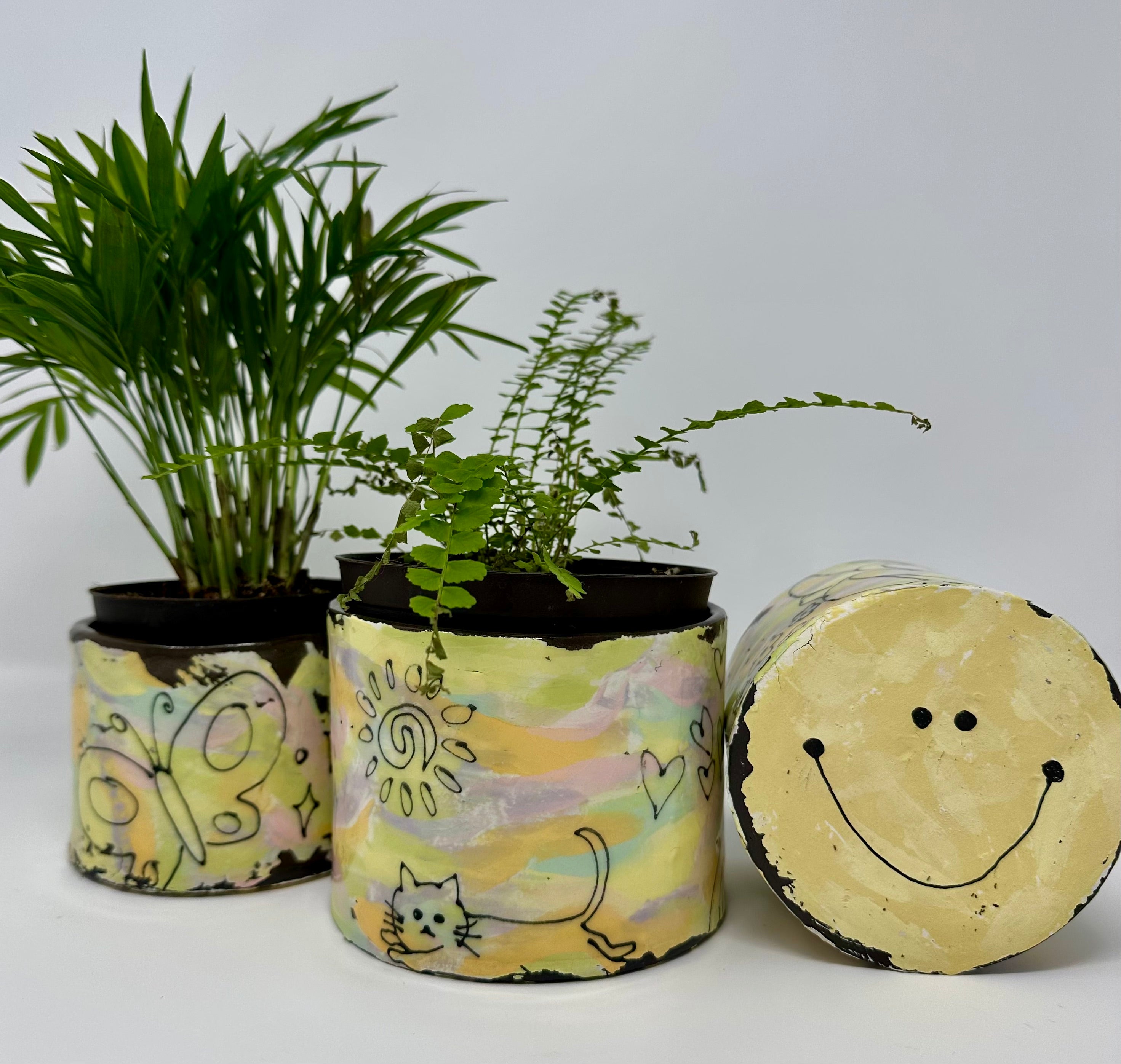 Colorful  decorative planters with colorful designs on a white background
